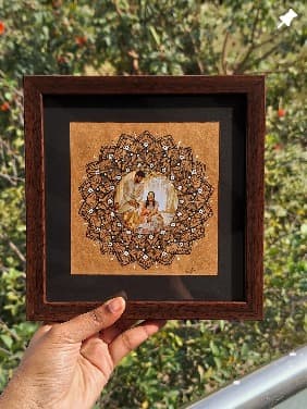 Framed mandala with a photo at its centre, from the studio